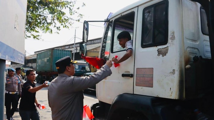 **Peringatan HUT ke-80 RI, Polres Priok Berikan Bendera Merah Putih kepada Masyarakat**